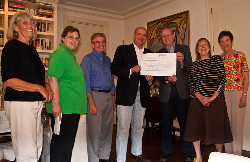 Board presents a $1,1581 check to our 2013 Raffle winner!