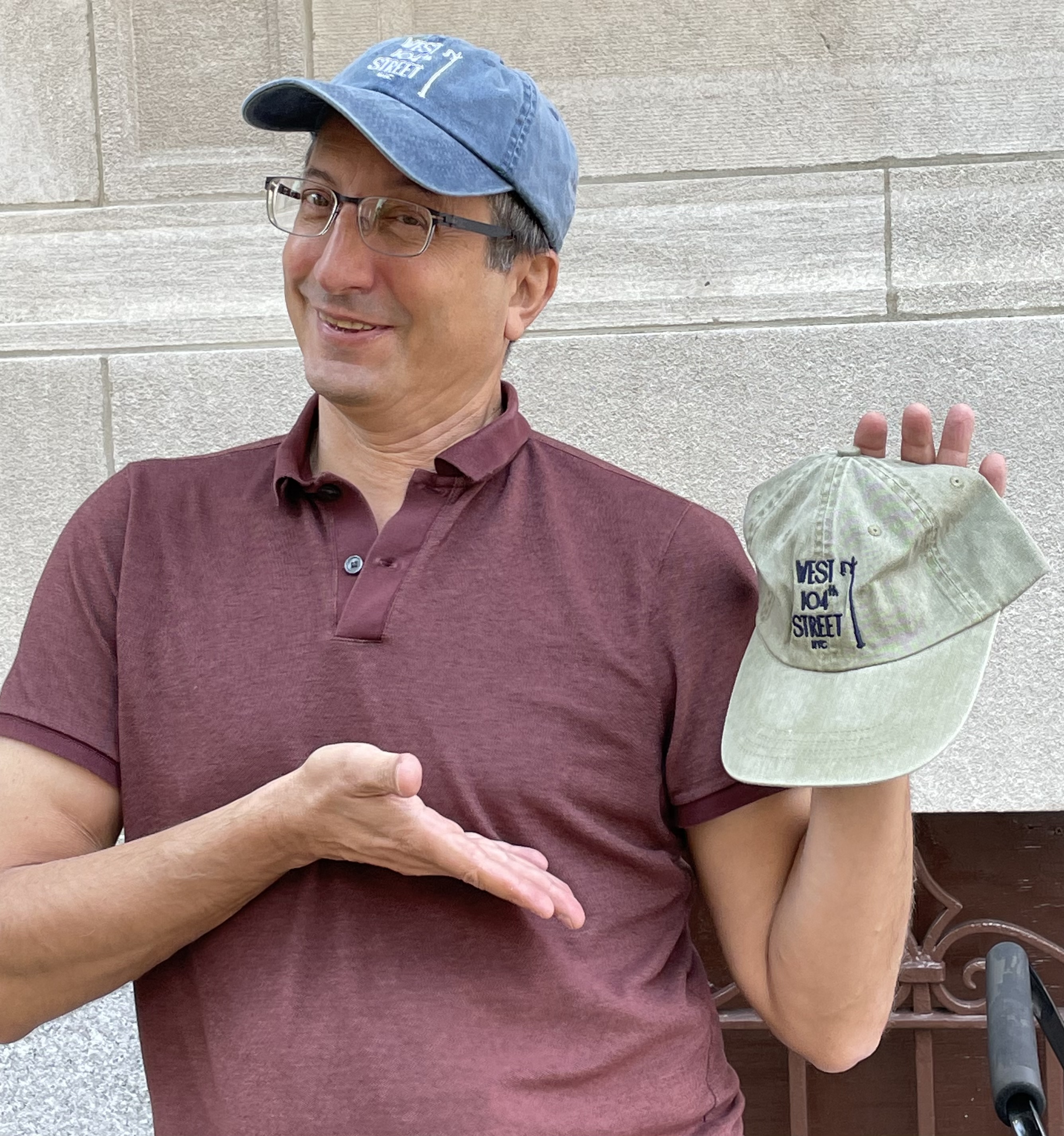 Steve Zirinsky displays two baseball hat styles