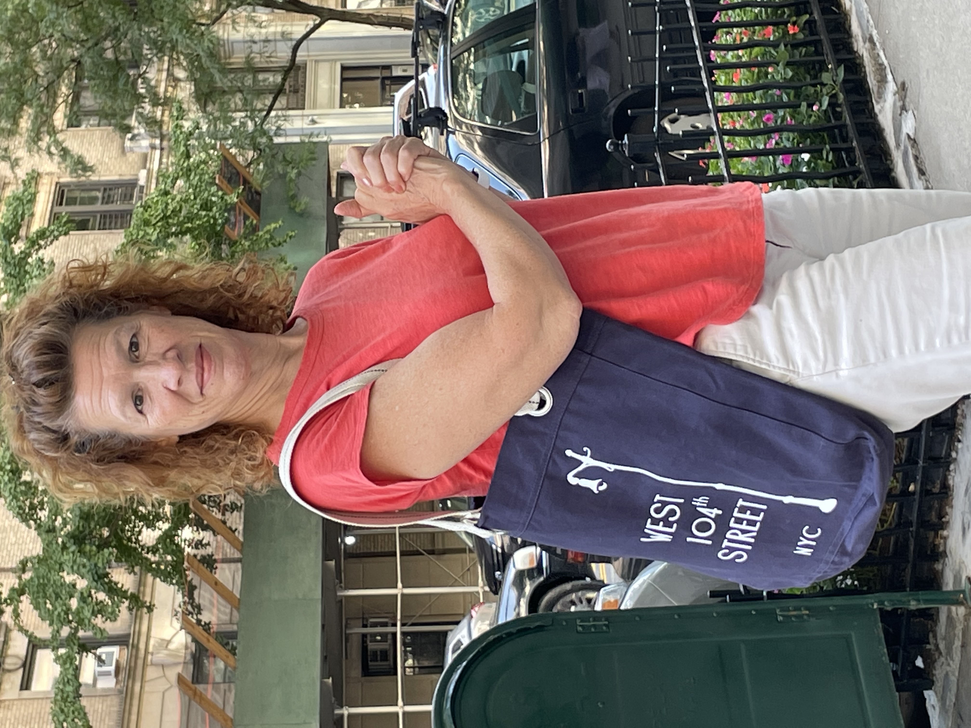 Mary Jo Di Gennaro flexes with a blue 104th Street Block Association shoulder tote bag