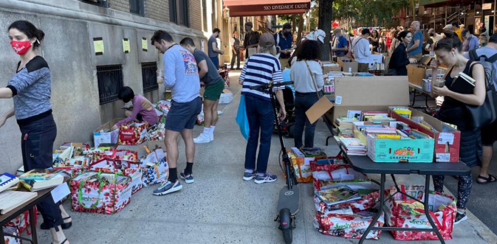 Shoppers browsing for Books at the annual West 104th Street Yard Sale.