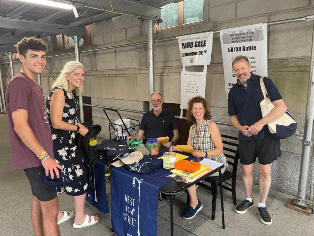 Block neighbors visit the raffle table for the 2023 yard sale